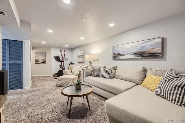 living room featuring carpet flooring and a textured ceiling