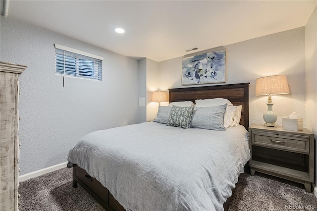 bedroom with dark colored carpet