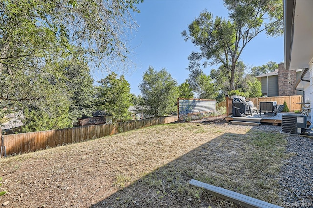 view of yard featuring a deck and cooling unit