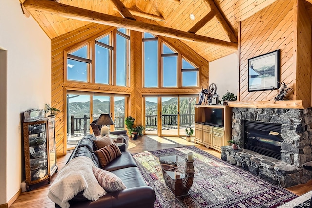 10450 Hondah Dr, Littleton, CO 80127 - living room featuring wooden ceiling, light wood finished floors, beamed ceiling, a stone fireplace, and high vaulted ceiling