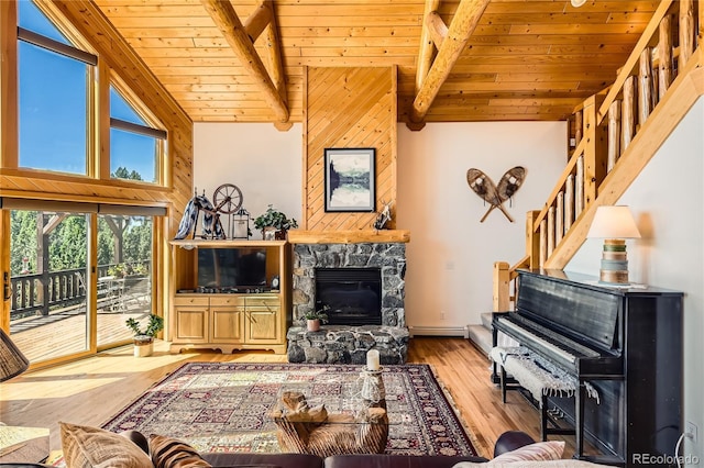 10450 Hondah Dr, Littleton, CO 80127 - living area with wood ceiling, light wood-style floors, stairs, a baseboard radiator, and a fireplace