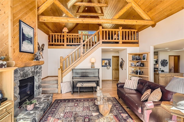 10450 Hondah Dr, Littleton, CO 80127 - living area featuring wood ceiling, beam ceiling, high vaulted ceiling, stairs, and wood finished floors