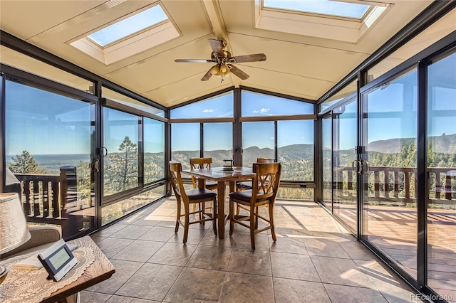 10450 Hondah Dr, Littleton, CO 80127 - sunroom / solarium with a skylight, floor to ceiling windows, a mountain view, vaulted ceiling, and a ceiling fan
