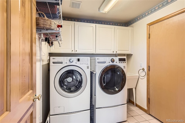 10450 Hondah Dr, Littleton, CO 80127 - laundry room featuring cabinet space, independent washer and dryer, and light tile patterned flooring