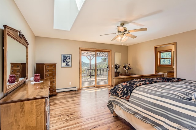 10450 Hondah Dr, Littleton, CO 80127 - bedroom with access to outside, wood finished floors, a baseboard heating unit, ceiling fan, and a skylight