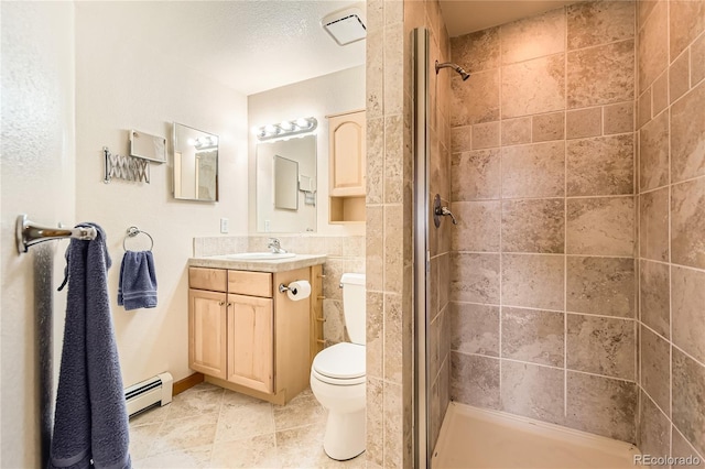 10450 Hondah Dr, Littleton, CO 80127 - bathroom with a stall shower, baseboard heating, vanity, toilet, and tile patterned floors