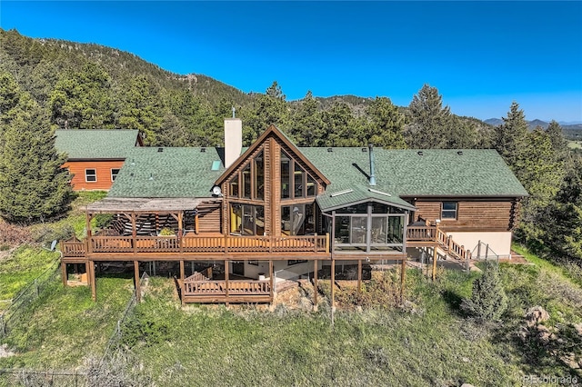 10450 Hondah Dr, Littleton, CO 80127 - rear view of house featuring a chimney, a deck with mountain view, log siding, and stairs