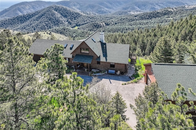 10450 Hondah Dr, Littleton, CO 80127 - view of subject property featuring a forest and a mountain backdrop