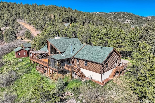 10450 Hondah Dr, Littleton, CO 80127 - view of subject property with a heavily wooded area