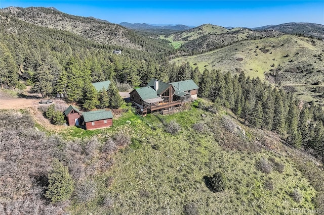 10450 Hondah Dr, Littleton, CO 80127 - aerial view of property and surrounding area with a heavily wooded area and a mountainous background