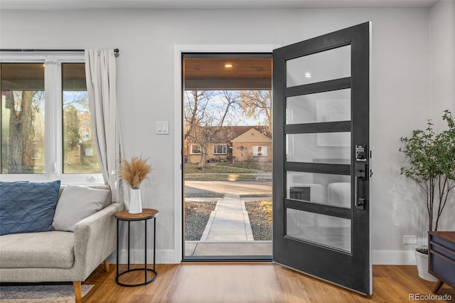1220 Ash St, Denver, CO 80220 - doorway featuring baseboards and wood finished floors
