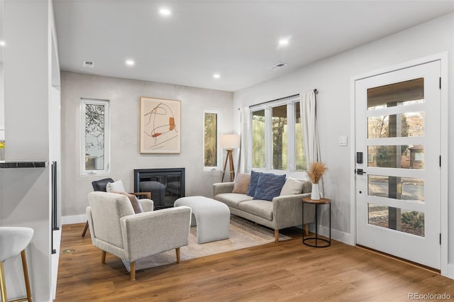 1220 Ash St, Denver, CO 80220 - living room featuring recessed lighting, light wood-type flooring, visible vents, and a glass covered fireplace