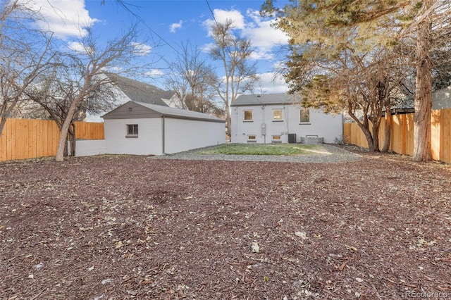 1220 Ash St, Denver, CO 80220 - back of property featuring a fenced backyard, an outdoor structure, and cooling unit