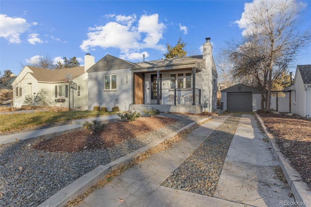 1220 Ash St, Denver, CO 80220 - bungalow-style house with a chimney, driveway, an outdoor structure, a detached garage, and a porch