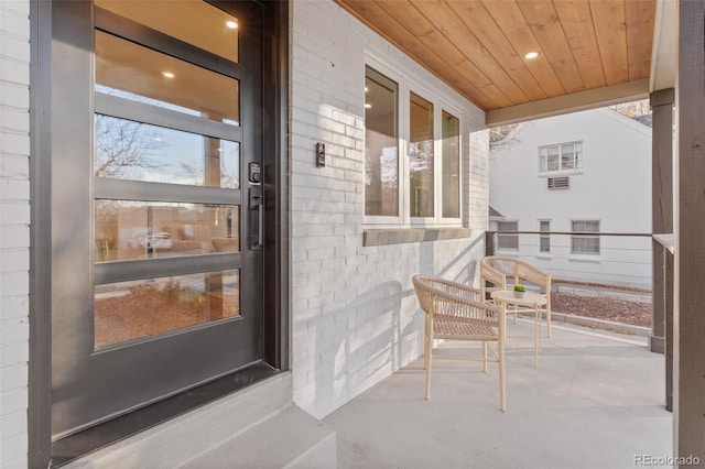 1220 Ash St, Denver, CO 80220 - property entrance featuring a porch and brick siding