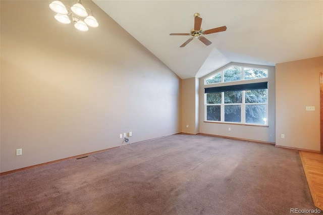 interior space featuring lofted ceiling, ceiling fan with notable chandelier, and light colored carpet