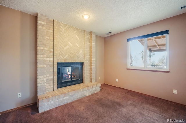 unfurnished living room featuring carpet flooring, a textured ceiling, and a fireplace