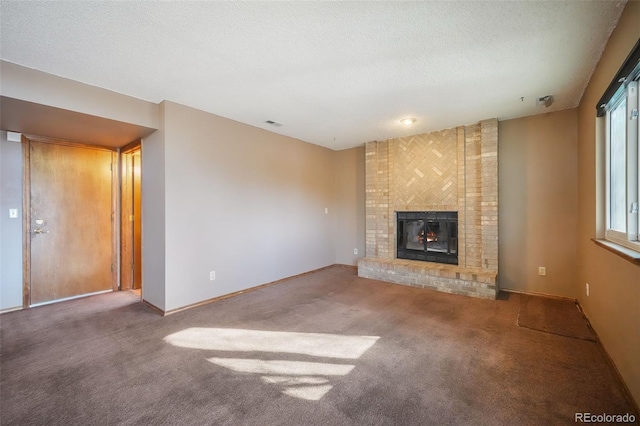 unfurnished living room with carpet, a textured ceiling, and a fireplace