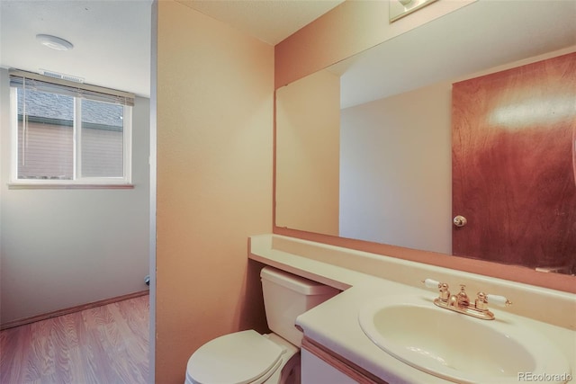 bathroom with vanity, hardwood / wood-style floors, and toilet