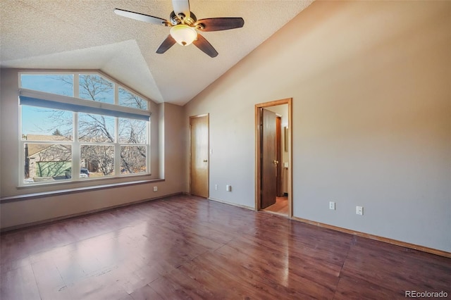 unfurnished bedroom featuring lofted ceiling, connected bathroom, hardwood / wood-style floors, and a textured ceiling