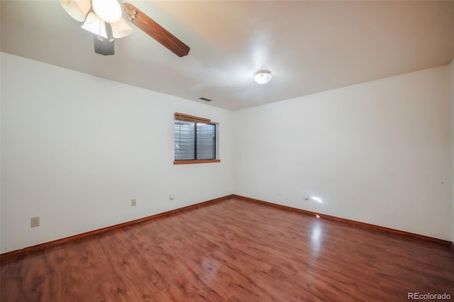 empty room with dark wood-type flooring and ceiling fan