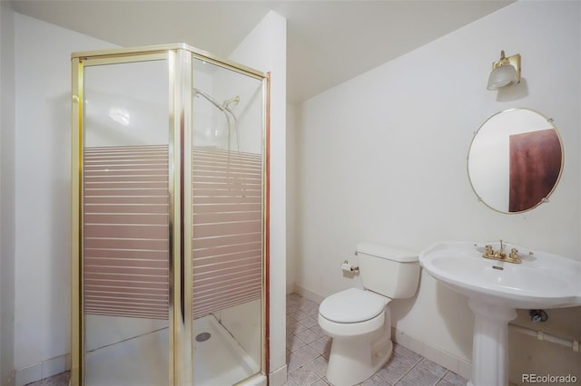 bathroom featuring tile patterned flooring, sink, toilet, and walk in shower