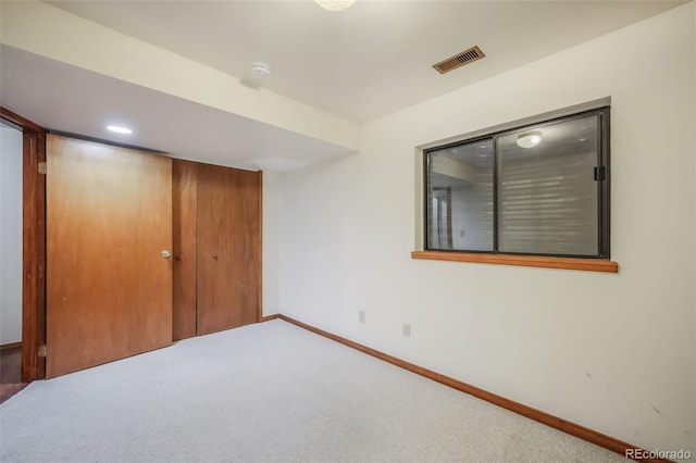 unfurnished bedroom with a closet and carpet flooring