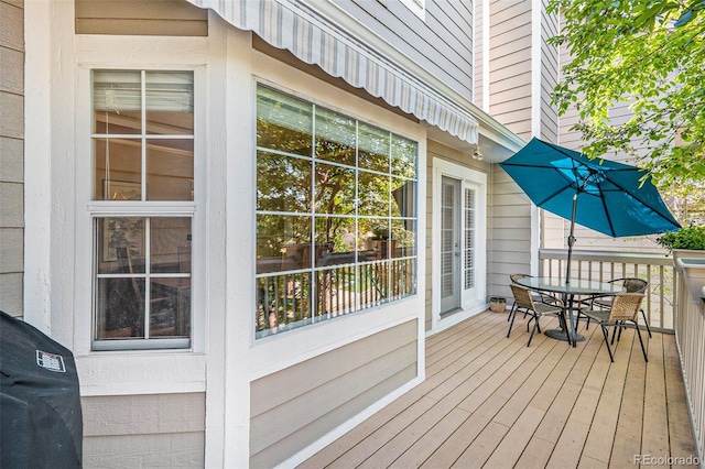 wooden terrace featuring outdoor dining space