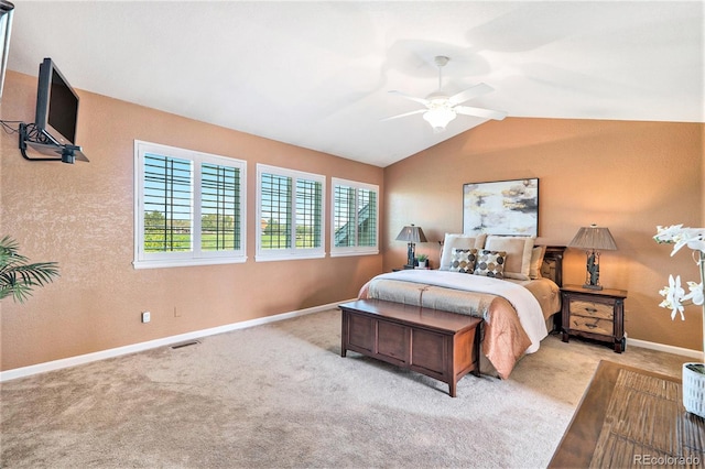 carpeted bedroom featuring lofted ceiling, baseboards, and a ceiling fan