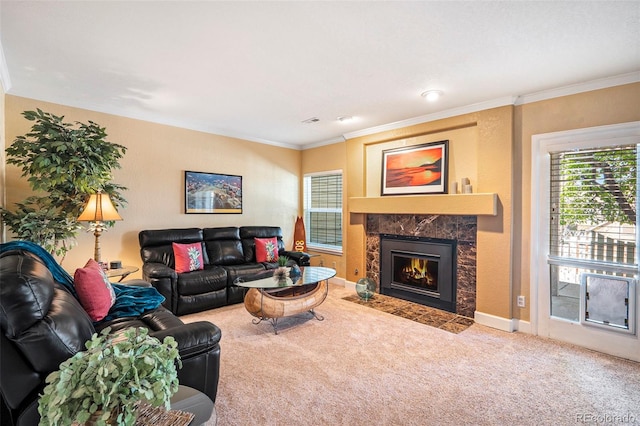 living area with carpet, a fireplace, ornamental molding, and baseboards