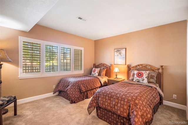 carpeted bedroom with baseboards