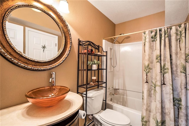 bathroom with a textured wall, a sink, shower / bath combo, and toilet