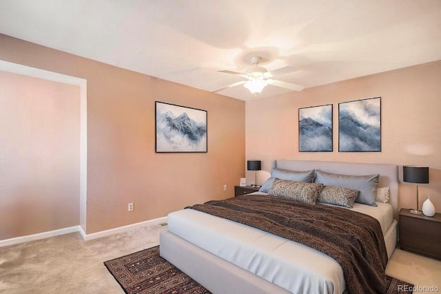 carpeted bedroom featuring baseboards and a ceiling fan