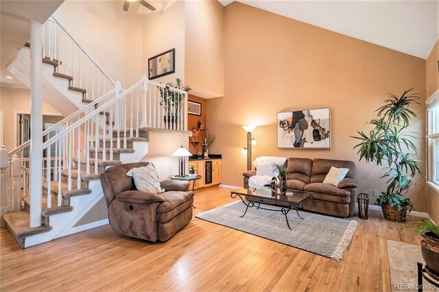 9875 Greensview Cir, Lone Tree, CO 80124 - living room with wood finished floors, high vaulted ceiling, stairway, and baseboards