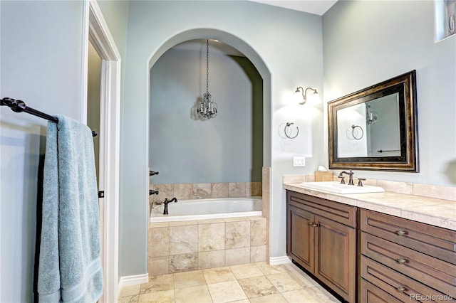 bathroom featuring a garden tub and vanity