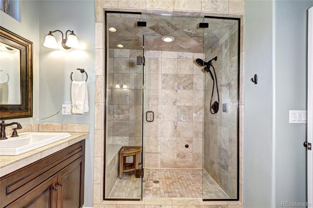 bathroom with a shower stall and vanity