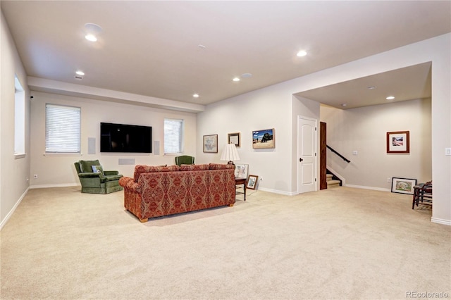 living room featuring recessed lighting, light colored carpet, baseboards, and stairs