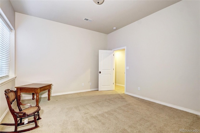 sitting room featuring visible vents, light carpet, and baseboards