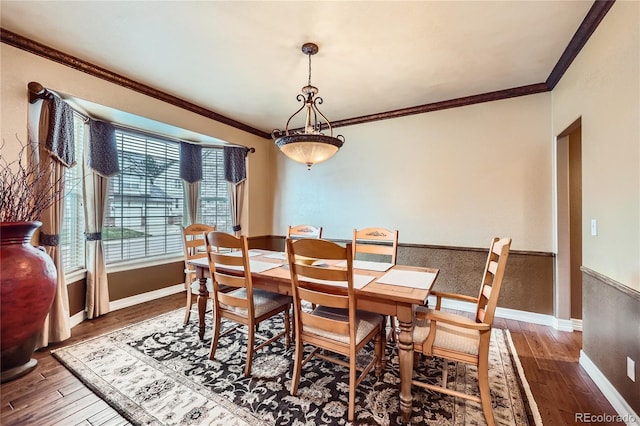527 Stonemont Dr, Castle Pines, CO 80108 - dining space featuring hardwood / wood-style flooring, ornamental molding, baseboards, and wainscoting