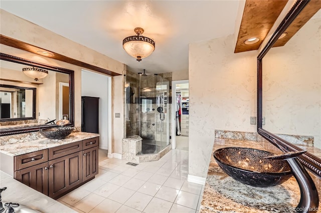 527 Stonemont Dr, Castle Pines, CO 80108 - full bath featuring a stall shower, tile patterned floors, two vanities, and baseboards