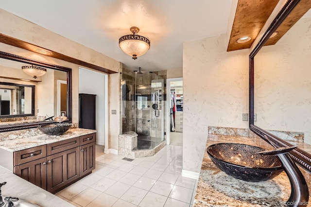 527 Stonemont Dr, Castle Pines, CO 80108 - full bath featuring a shower stall, tile patterned flooring, two vanities, and baseboards
