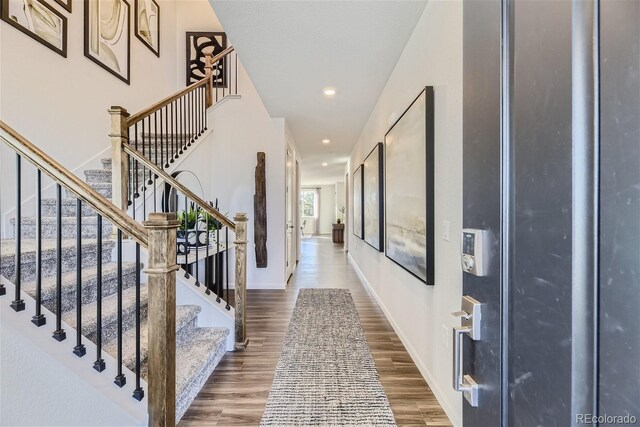 foyer featuring recessed lighting, baseboards, and wood finished floors