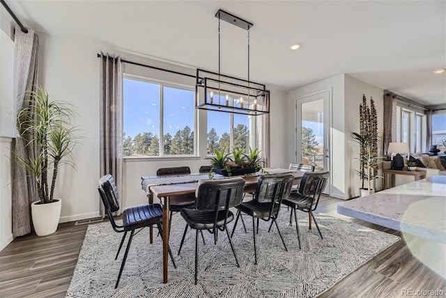 dining space with plenty of natural light, recessed lighting, baseboards, and wood finished floors