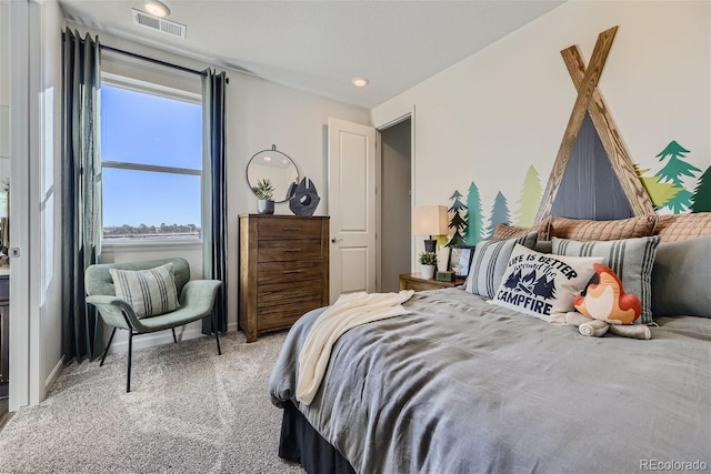 carpeted bedroom featuring visible vents and baseboards