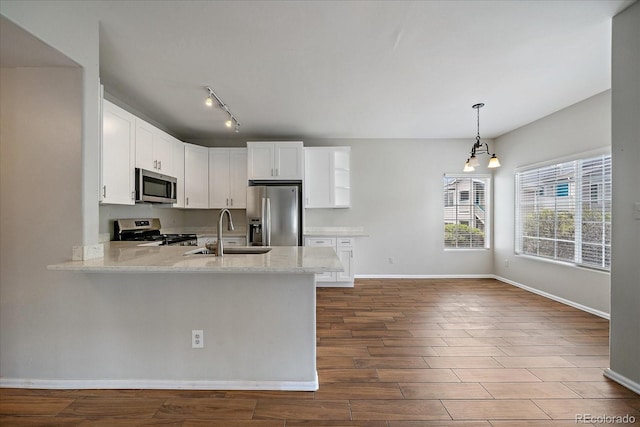 kitchen featuring stainless steel appliances, a sink, baseboards, white cabinetry, and dark wood-style flooring