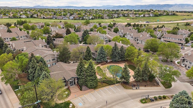 aerial view of property and surrounding area with nearby suburban area and a mountainous background