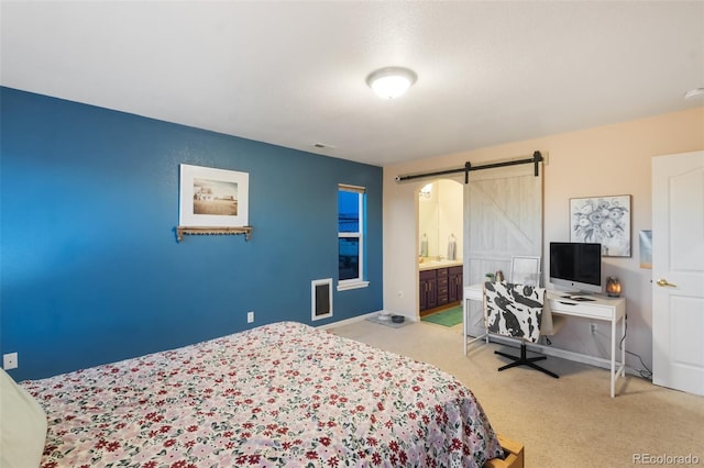 carpeted bedroom featuring a barn door, baseboards, and visible vents