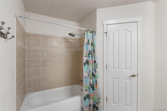 bathroom with shower / bath combo with shower curtain