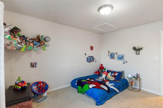 bedroom with carpet flooring, attic access, and baseboards