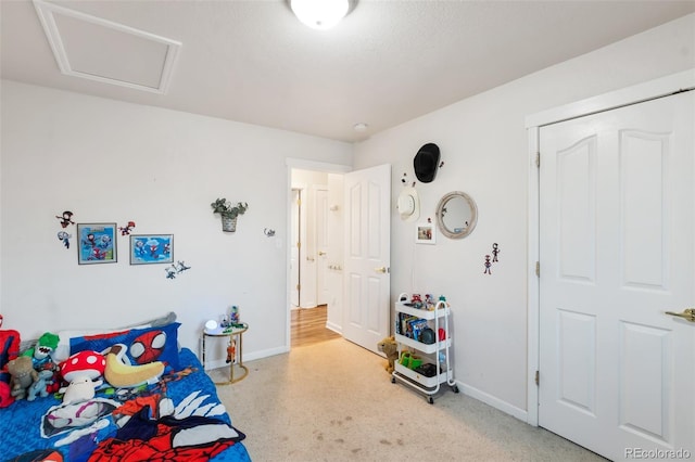 bedroom featuring attic access and baseboards